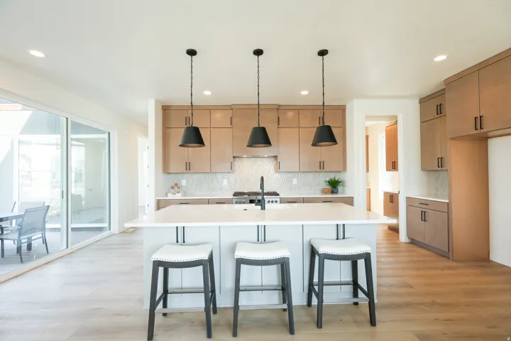 Kitchen featuring an island with countertop, wood-finish flooring, recessed lighting, and sliding glass doors