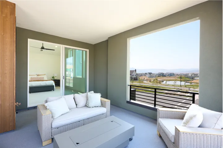 Spacious outdoor balcony with a black metal railing and expansive opening