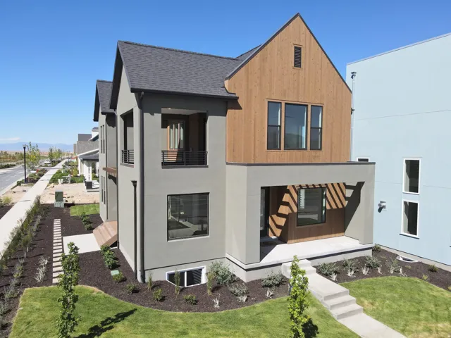 Contemporary architecture featuring a multi-textured facade with wood paneling and stucco