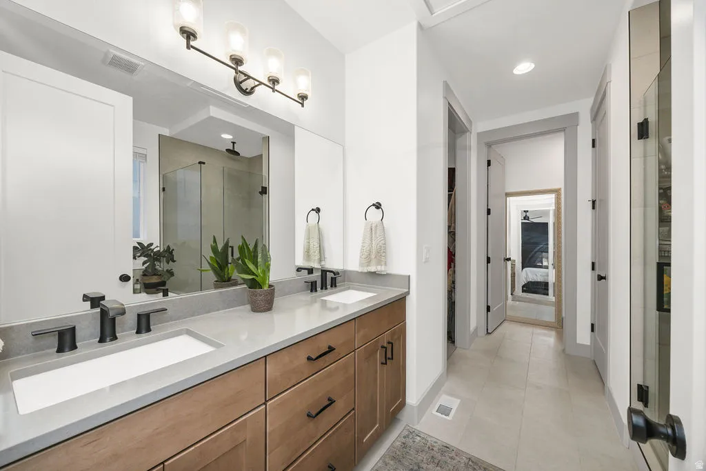 Dual vanity with integrated sinks, stone-finish countertop, and wood-finish cabinetry