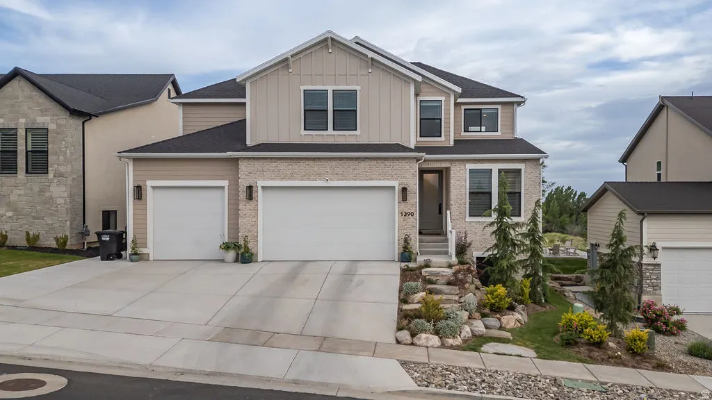 Contemporary two-story residence featuring a combination of horizontal siding, vertical board and batten siding, and stone veneer accents