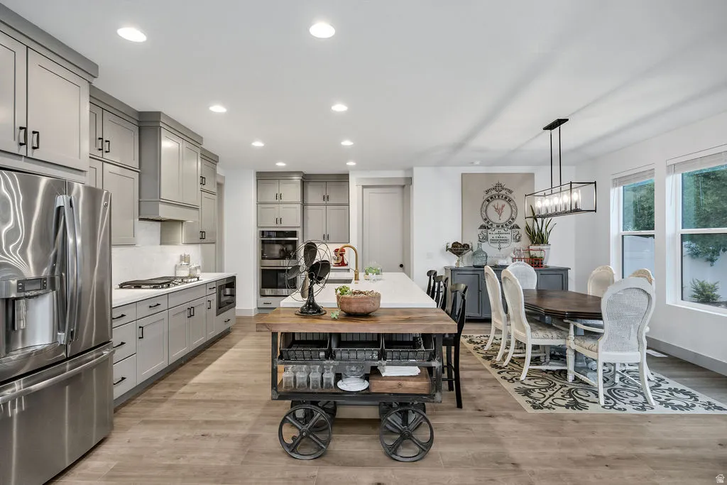 Open-concept kitchen and dining area featuring light wood-finish flooring