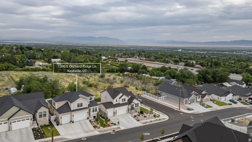 Newly constructed residential area featuring modern homes with dark shingled roofs and light-toned siding