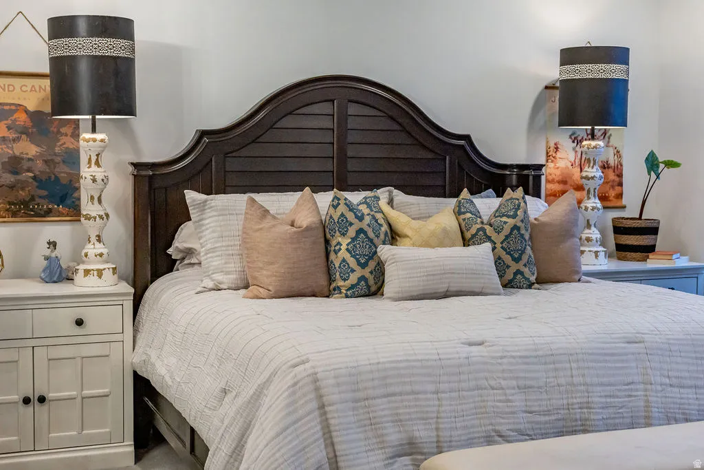 Dark wood headboard featuring a slatted design and curved top detail