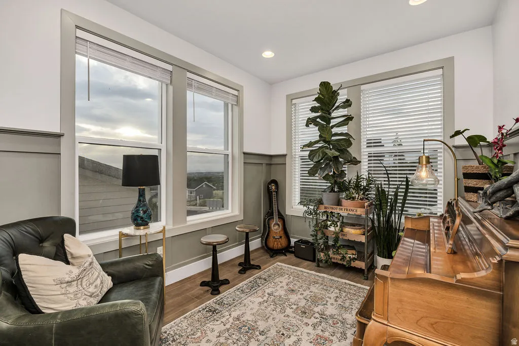 Room featuring wainscoting and wood-finish flooring