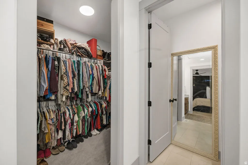 Walk-in closet with carpet flooring, recessed lighting, and dual-level hanging rods