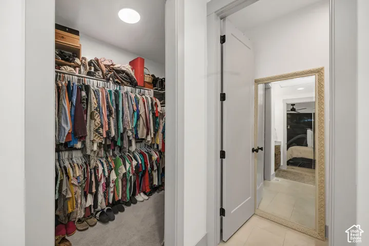 Walk-in closet with carpet flooring, recessed lighting, and dual-level hanging rods