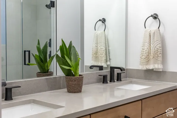 Dual undermount sinks set within a light-toned countertop, complemented by matte black faucets