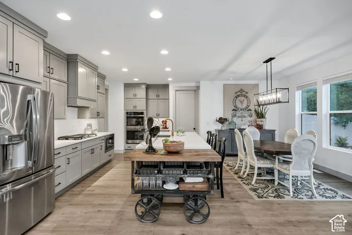 Open-concept kitchen and dining area featuring light wood-finish flooring