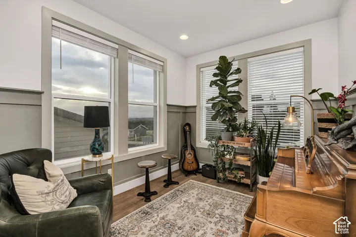 Room featuring wainscoting and wood-finish flooring