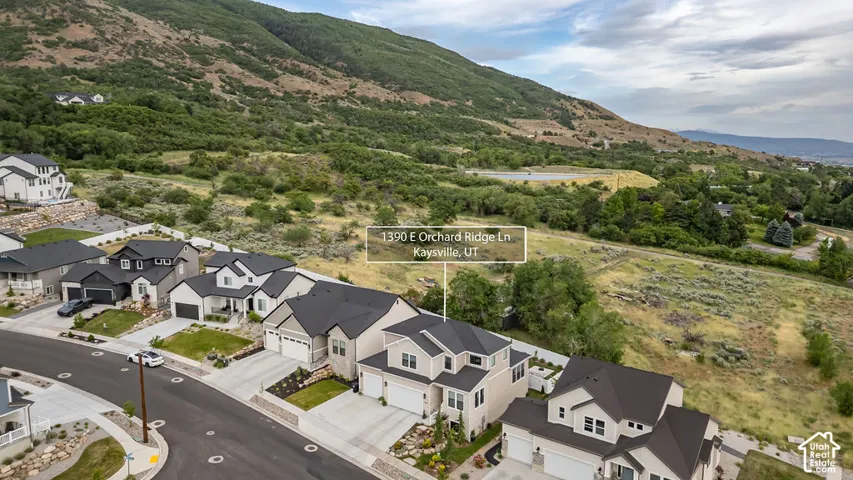 Modern suburban community featuring newly constructed homes with varied architectural styles, individual driveways, and manicured landscaping