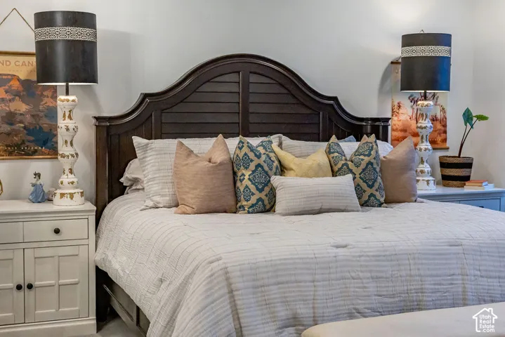 Dark wood headboard featuring a slatted design and curved top detail