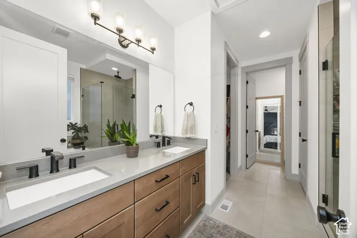 Dual vanity with integrated sinks, stone-finish countertop, and wood-finish cabinetry