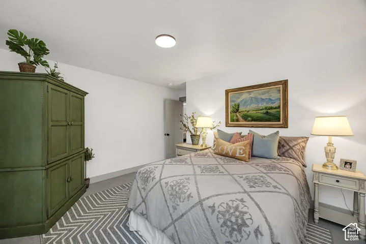 Carpeted bedroom featuring white walls and a ceiling light fixture