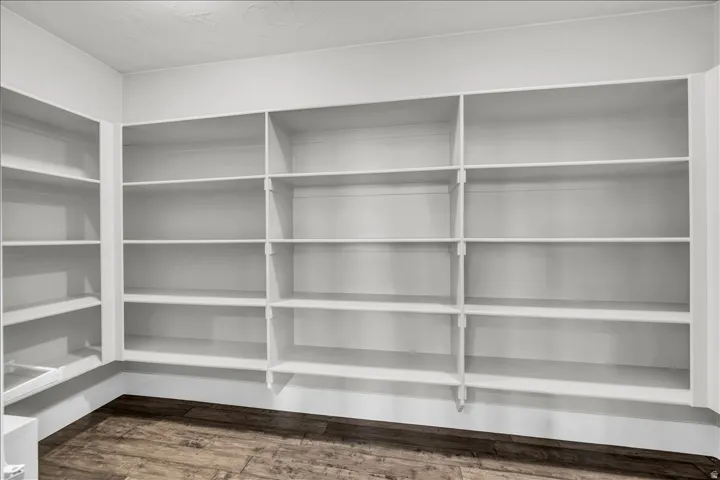 Spacious built-in shelving units in a neutral finish, providing extensive storage