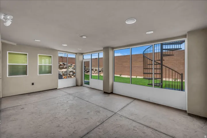 Expansive room featuring stamped concrete flooring and recessed lighting