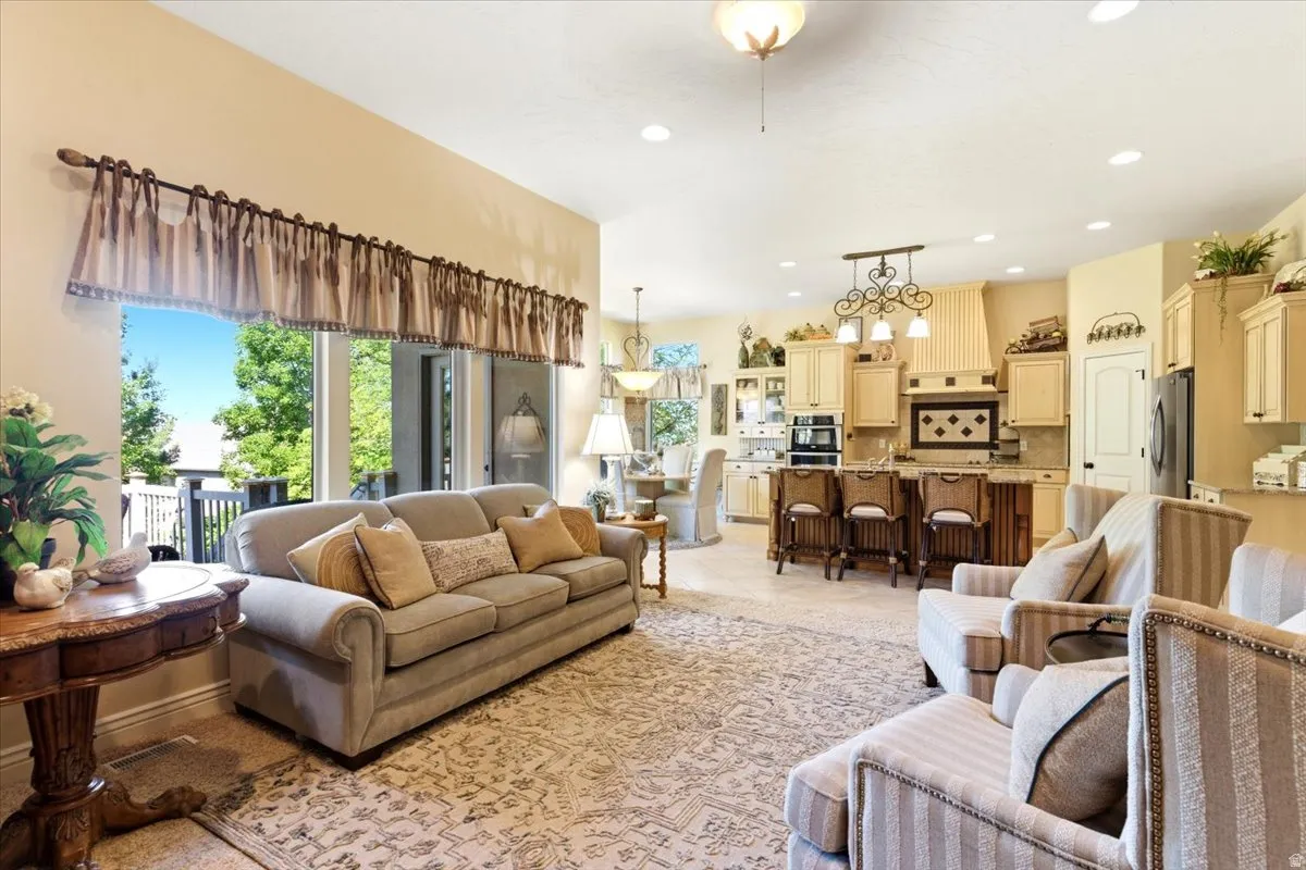 Open-concept living space featuring recessed lighting, a large window, and direct access to an outdoor deck