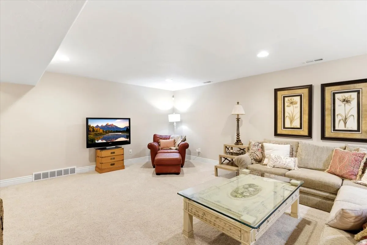 Spacious carpeted room featuring recessed lighting and neutral wall tones