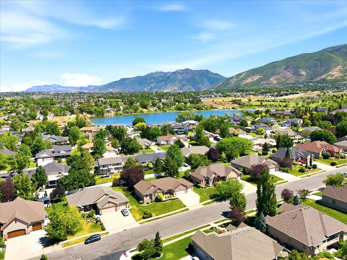 Residential development featuring single-story and multi-story homes, mature trees, and landscaping