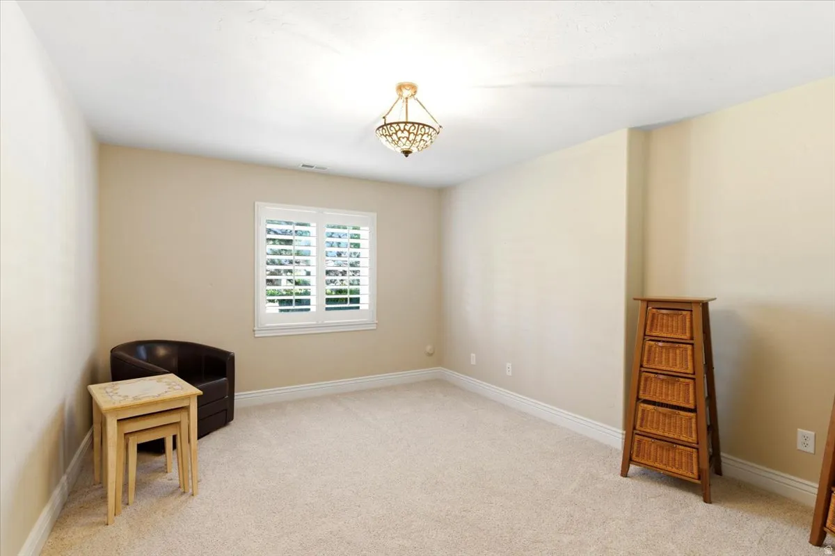 Room featuring neutral-toned walls, plush carpeting, and white baseboards