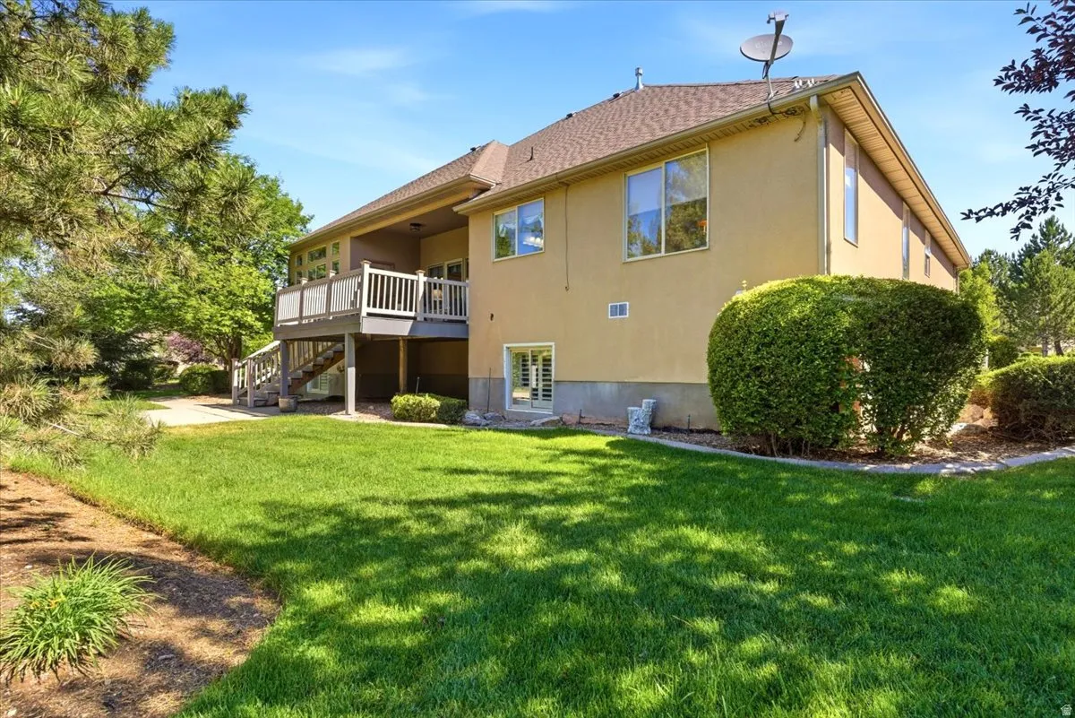 Expansive backyard with a manicured lawn and mature landscaping
