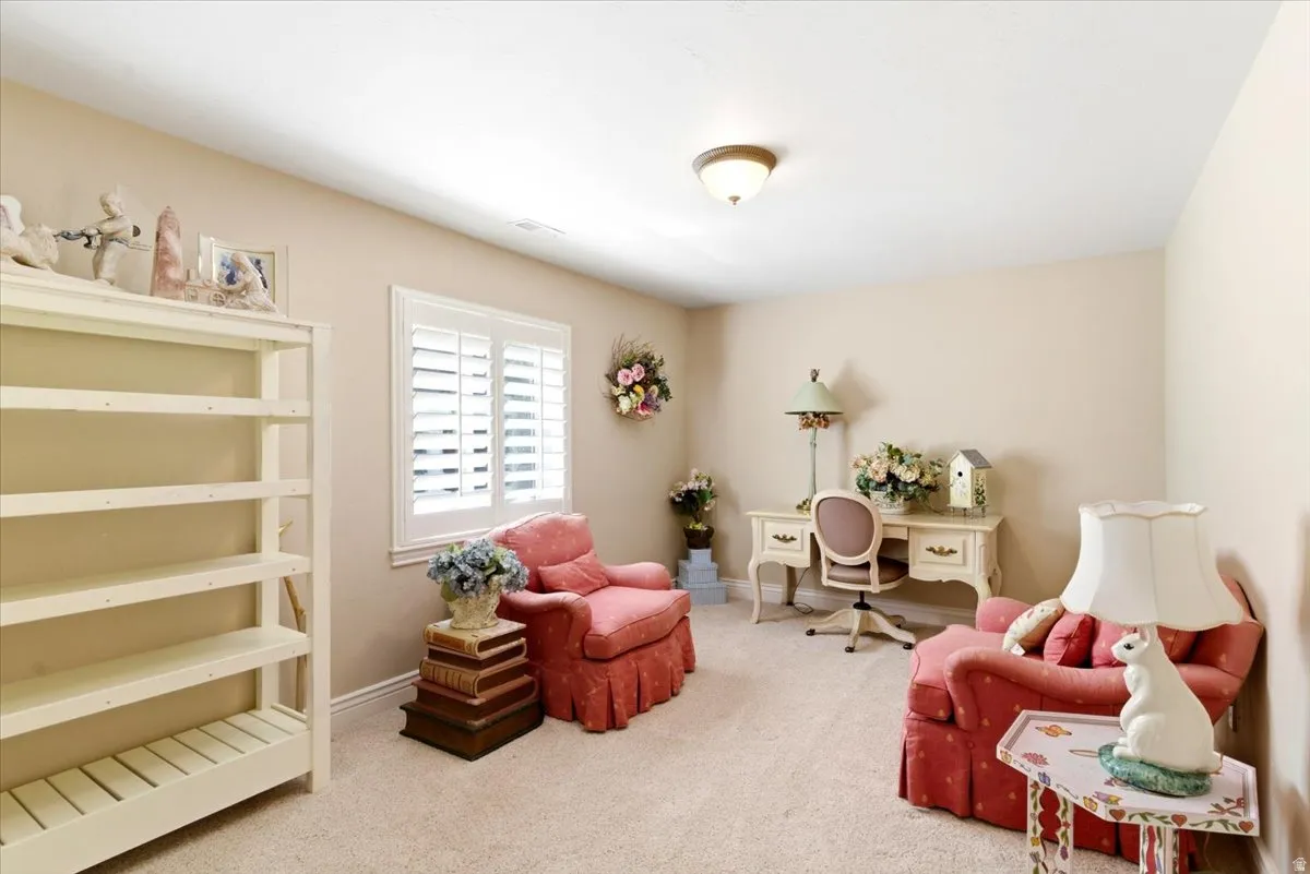 Room featuring light beige walls and a neutral carpet