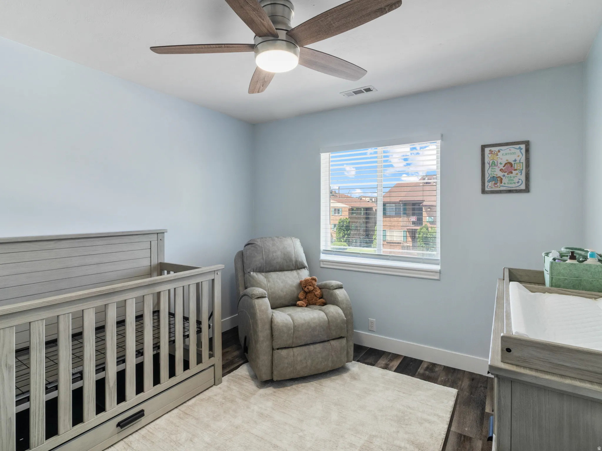 Bedroom 3 featuring a ceiling fan with light, a window with horizontal blinds, and wood-finish flooring