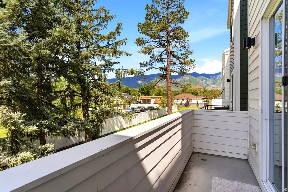 Private balcony featuring horizontal siding and a full glass sliding door