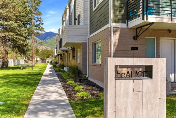 Modern townhome exterior featuring contemporary siding, brick accents, and a private balcony