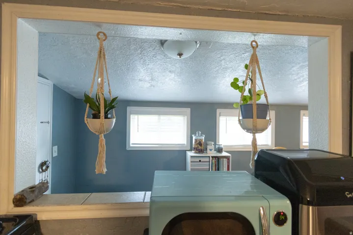Pass-through window with a tiled countertop and white trim