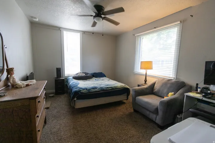 Bedroom featuring carpeted flooring and a ceiling fan with integrated lighting