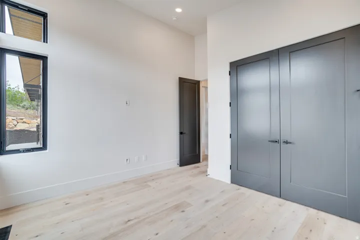 Light wood-finish flooring complements white walls and tall baseboards