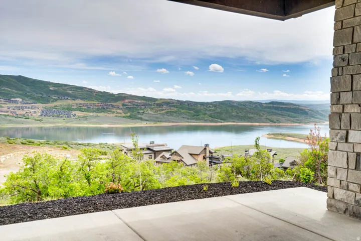 Concrete patio overlooking a lake and distant mountains