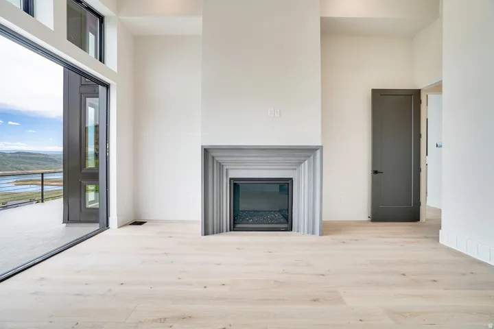 Contemporary interior featuring a central fireplace with a stepped stone surround and a glass-front insert