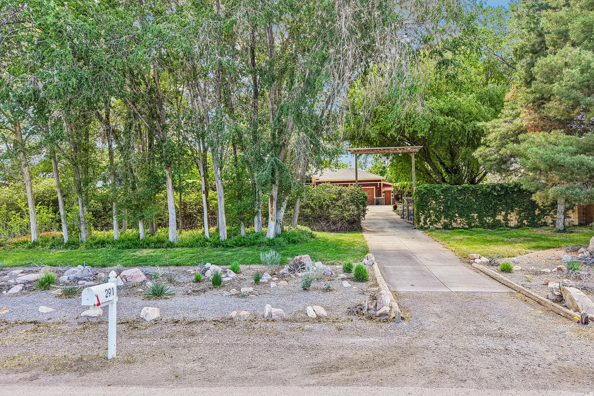 Concrete driveway with decorative wood trellis entry