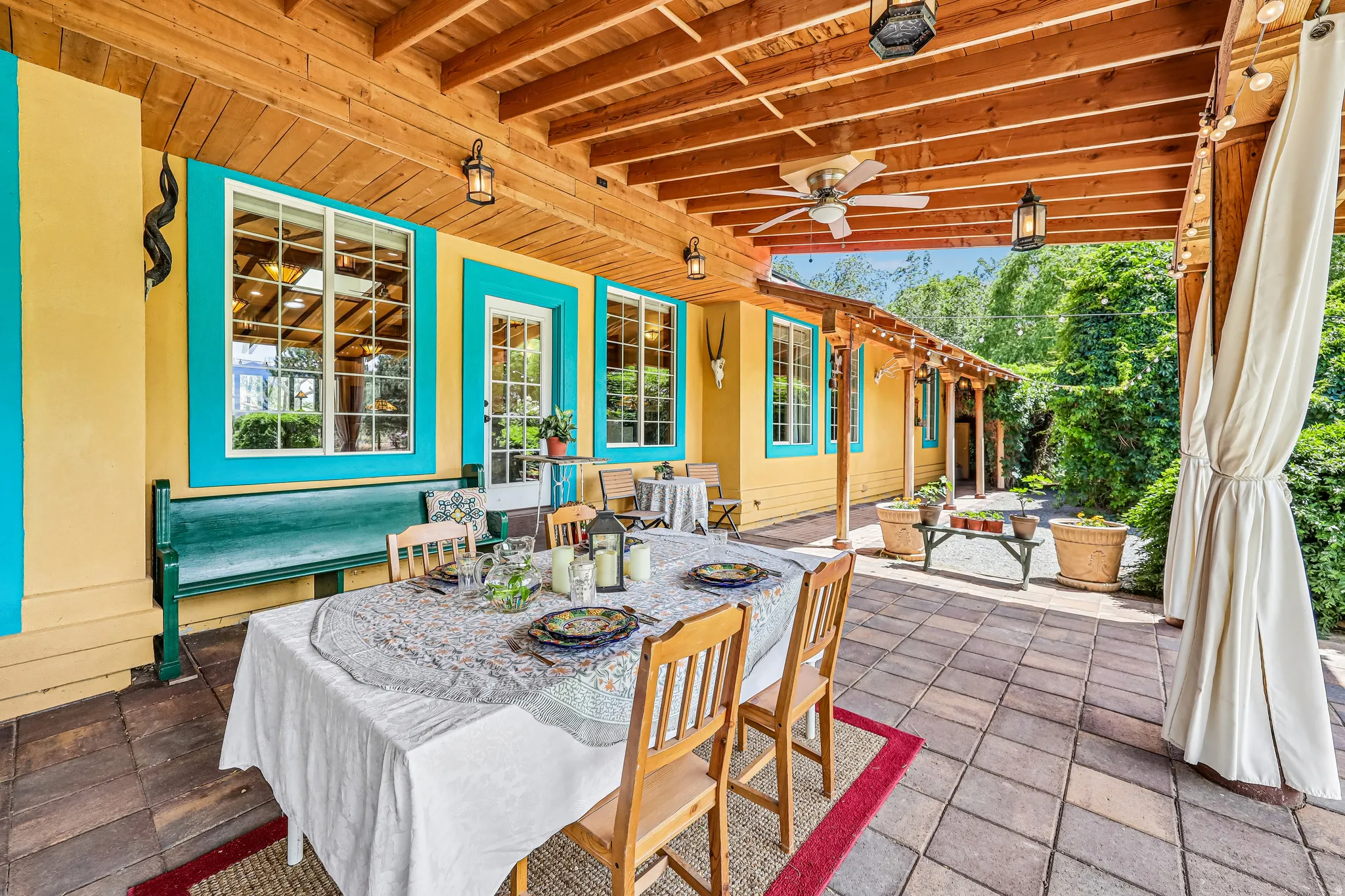 Covered outdoor patio featuring extensive paver flooring