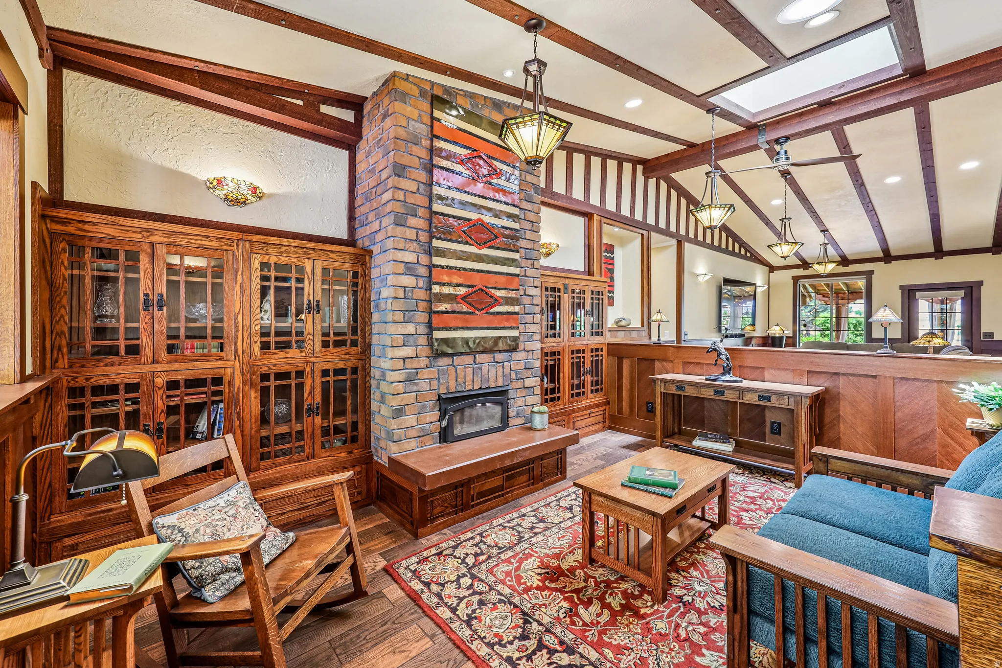 Living area featuring a floor-to-ceiling brick fireplace with a wood mantel
