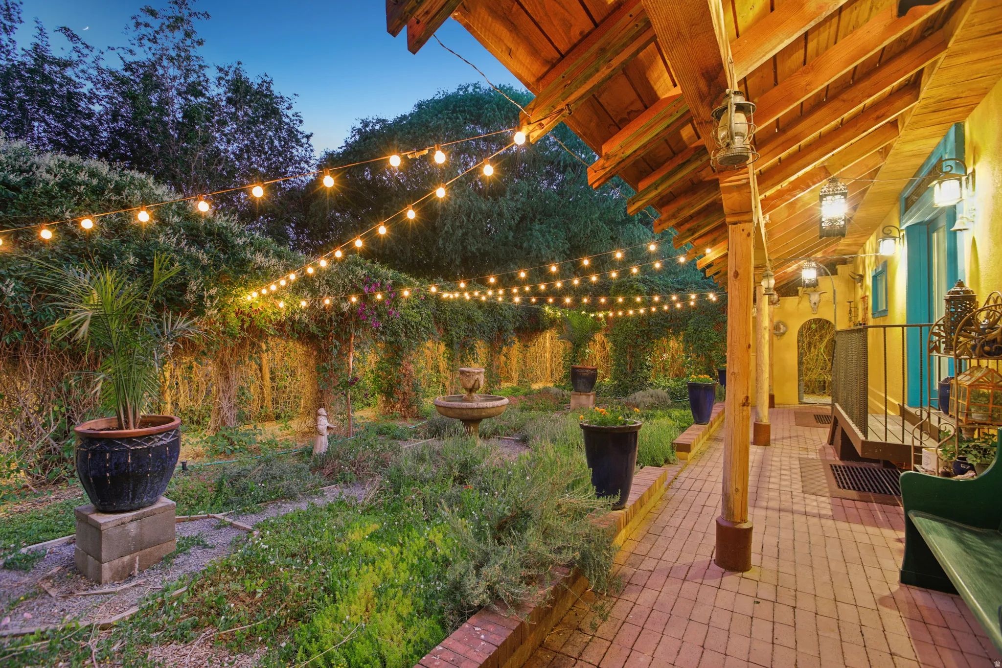 Covered patio with a brick paver floor and exposed wood beam ceiling