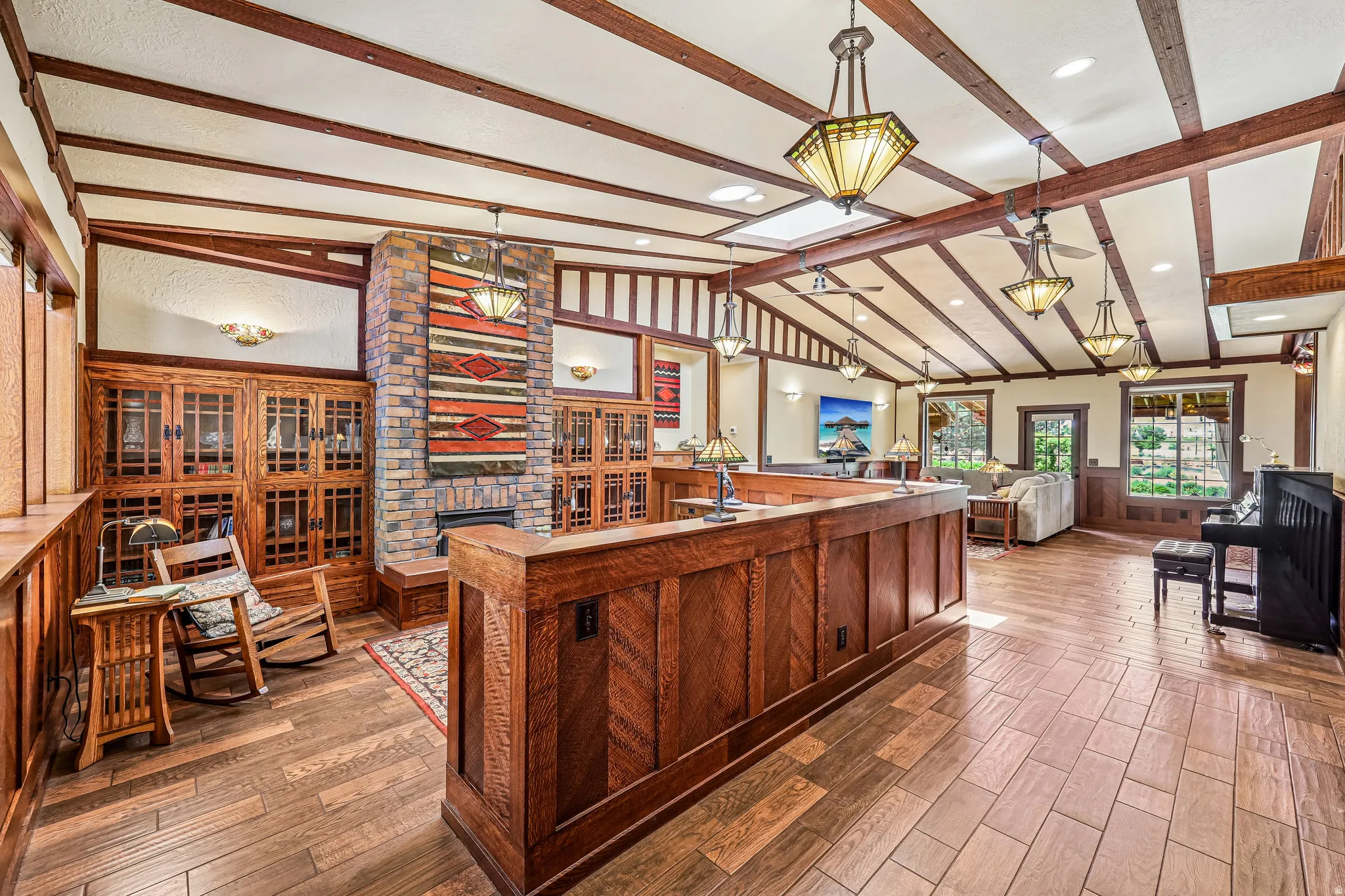 Vaulted beamed ceiling featuring multiple pendant lights and ceiling fans