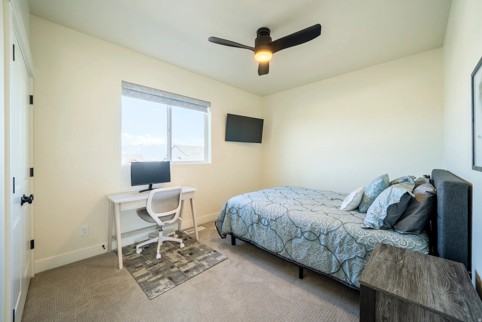 Carpeted room with a ceiling fan, a window with blinds, and light-colored walls
