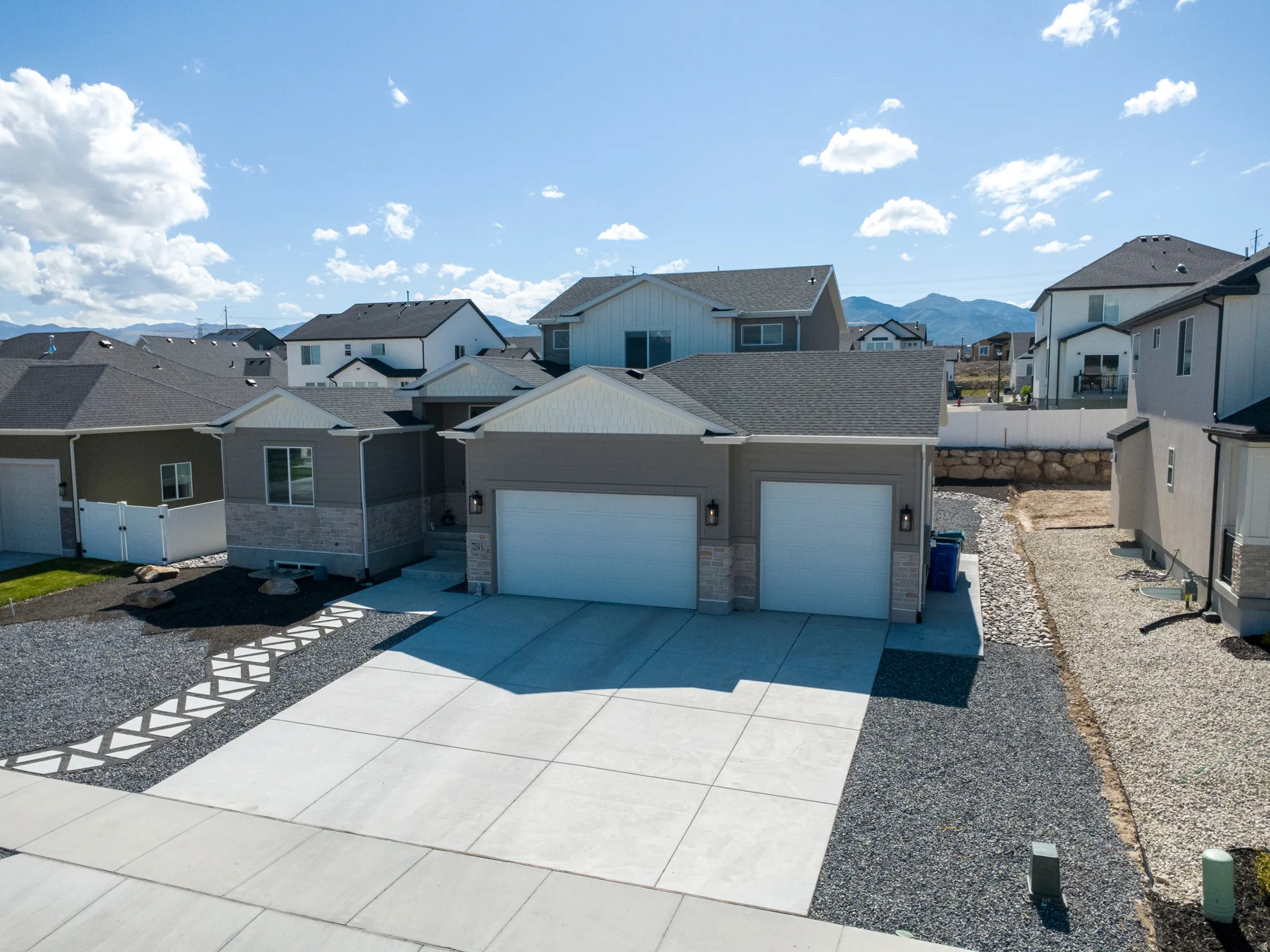 Contemporary exterior featuring gray siding and stone accents