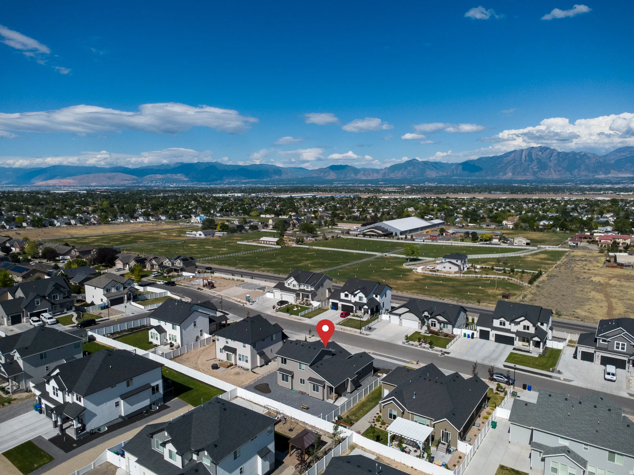 Aerial overview of a residential area with a prominent mountain range backdrop