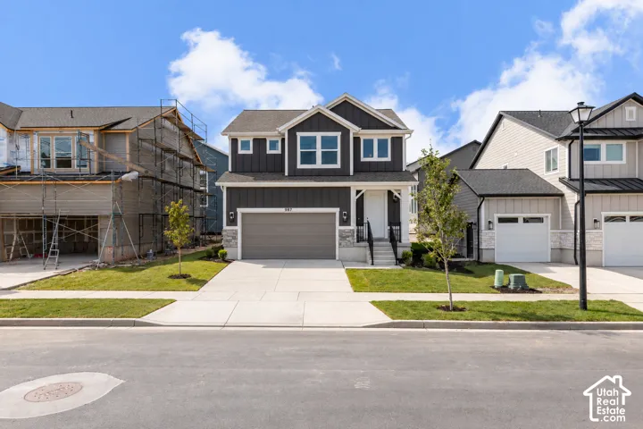 Contemporary two-story exterior with dark siding and white trim
