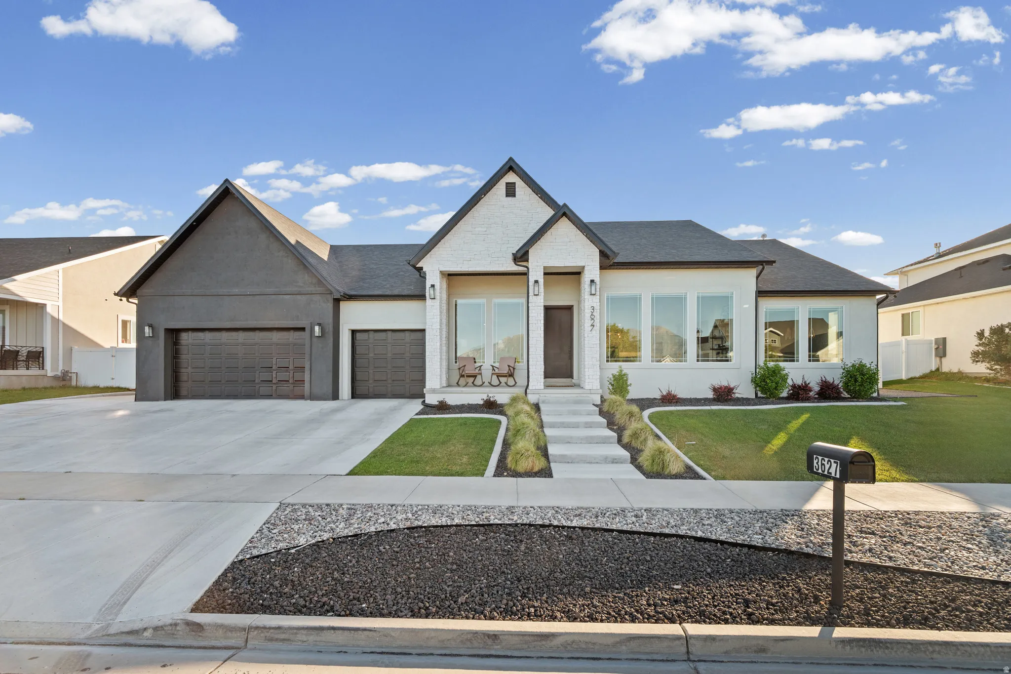 Contemporary exterior featuring a white stucco finish with dark trim accents