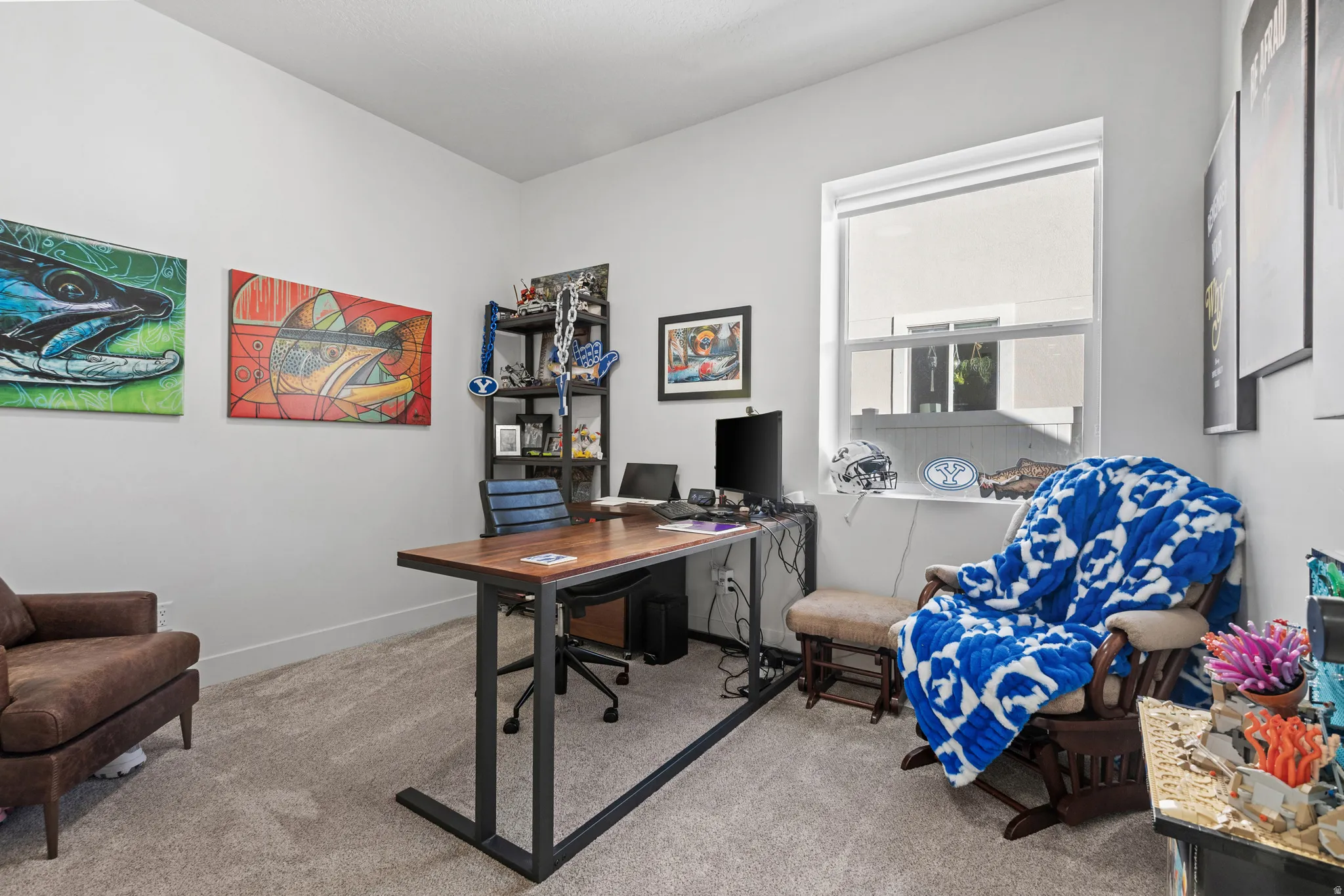Office space featuring light gray walls and plush carpet flooring