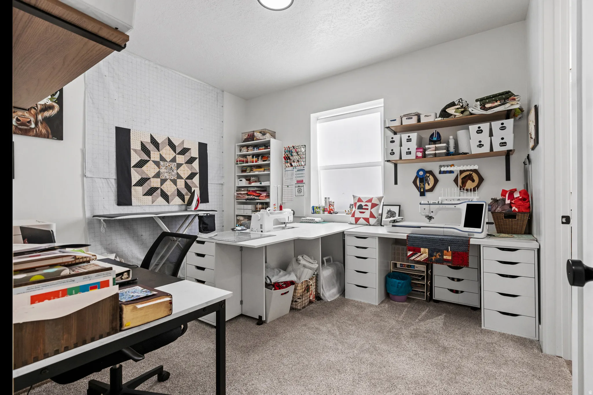 Dedicated hobby room featuring light gray carpet flooring and white walls