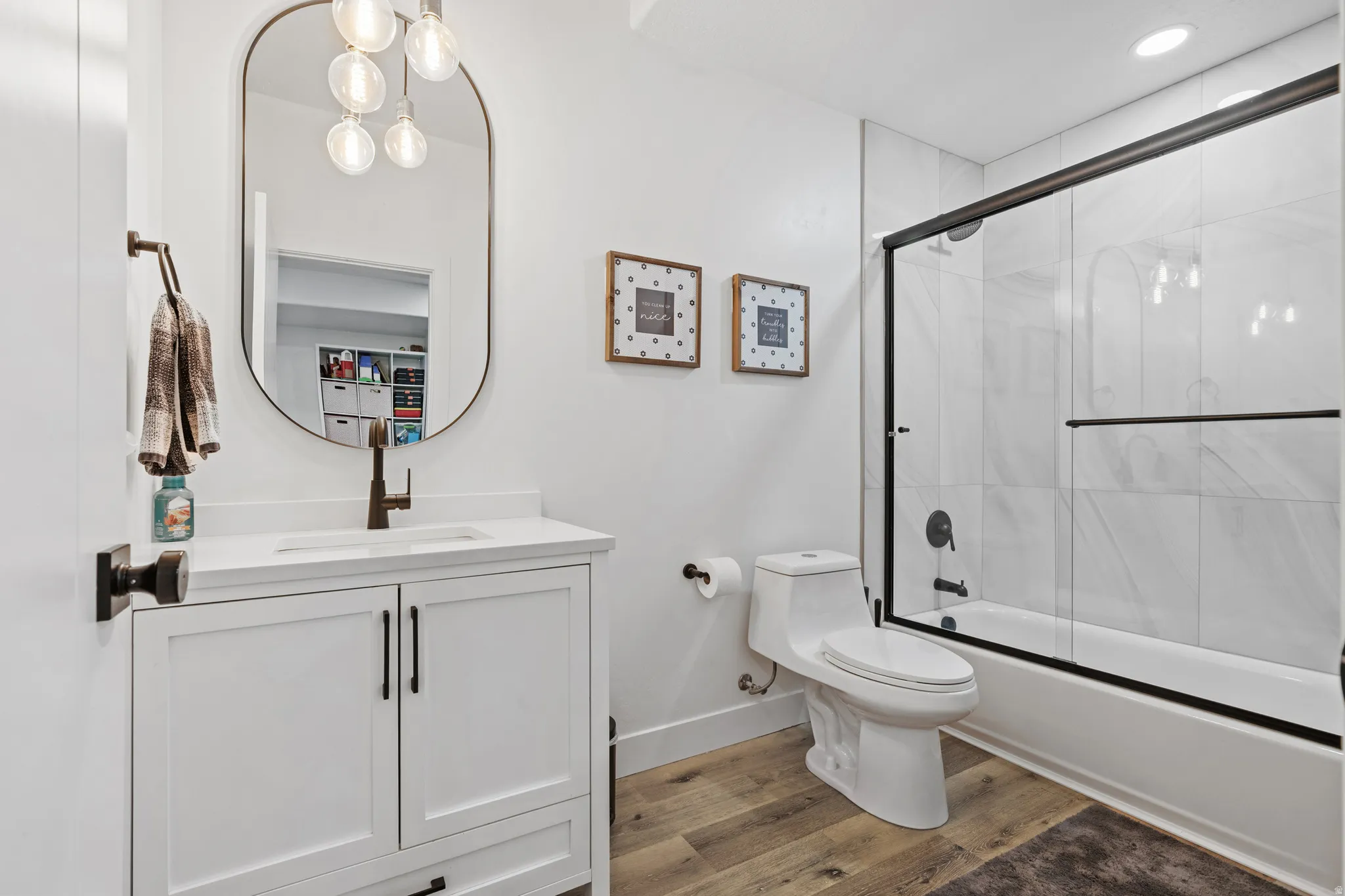 Bathroom featuring a white vanity with integrated sink, quartz countertop, and a black faucet