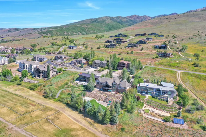 Expansive mountain landscape featuring multiple custom residences and abundant natural terrain