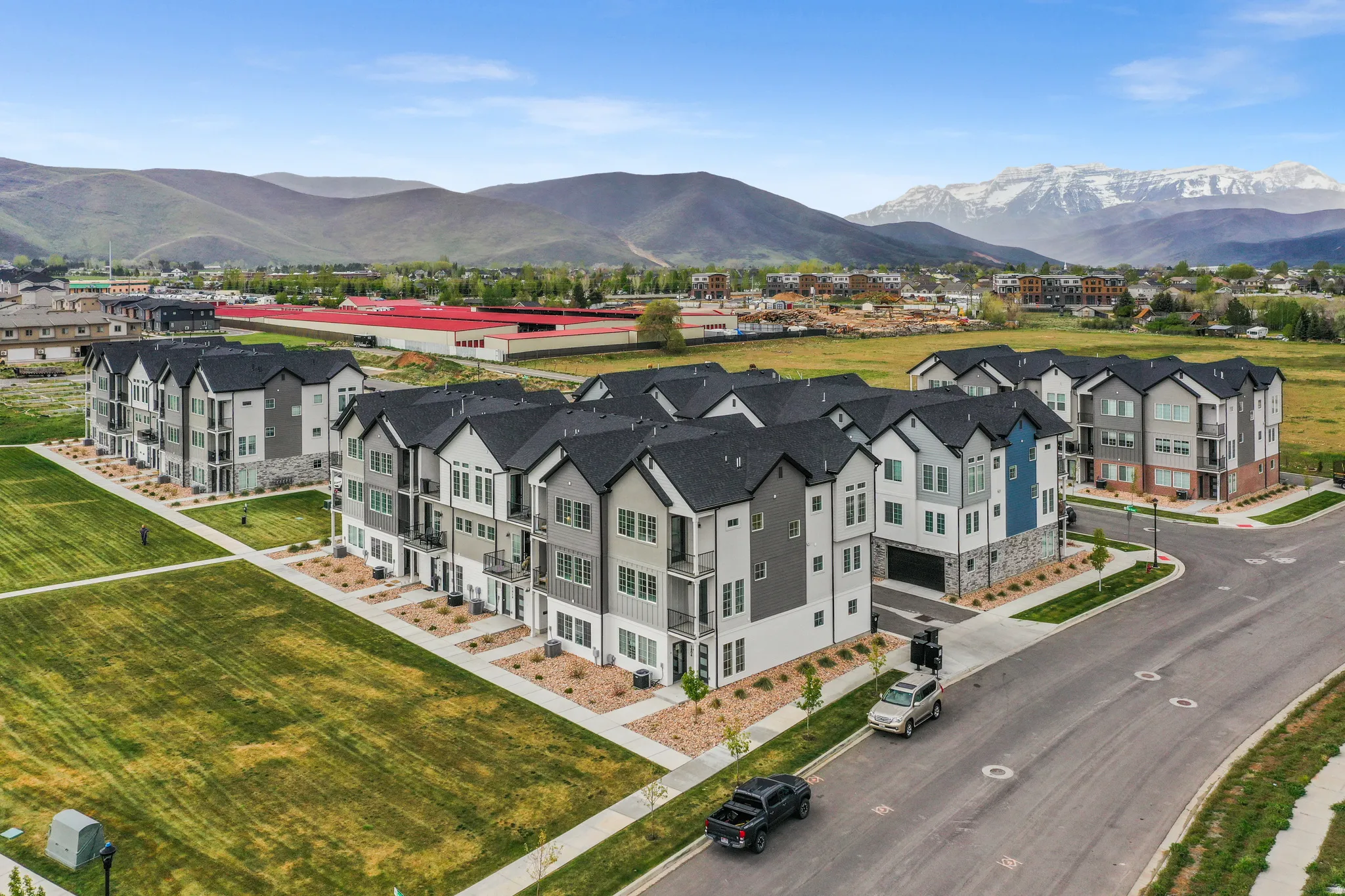 Modern residential complex featuring multi-story townhomes with contrasting exterior finishes