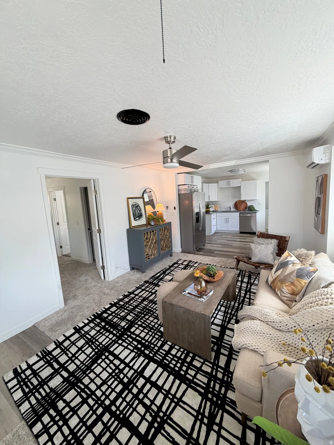 Open concept living area with recessed lighting, ceiling fan, and wood-finish flooring